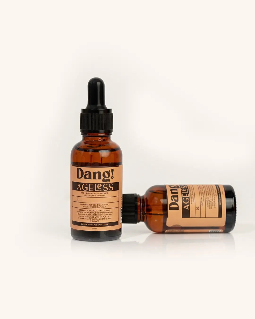Two bottles of Dang! Ageless serum on a white background