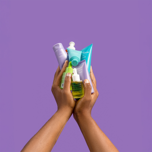 A lady's hand holding multiple products in a guide on how to apply your skincare products like a pro