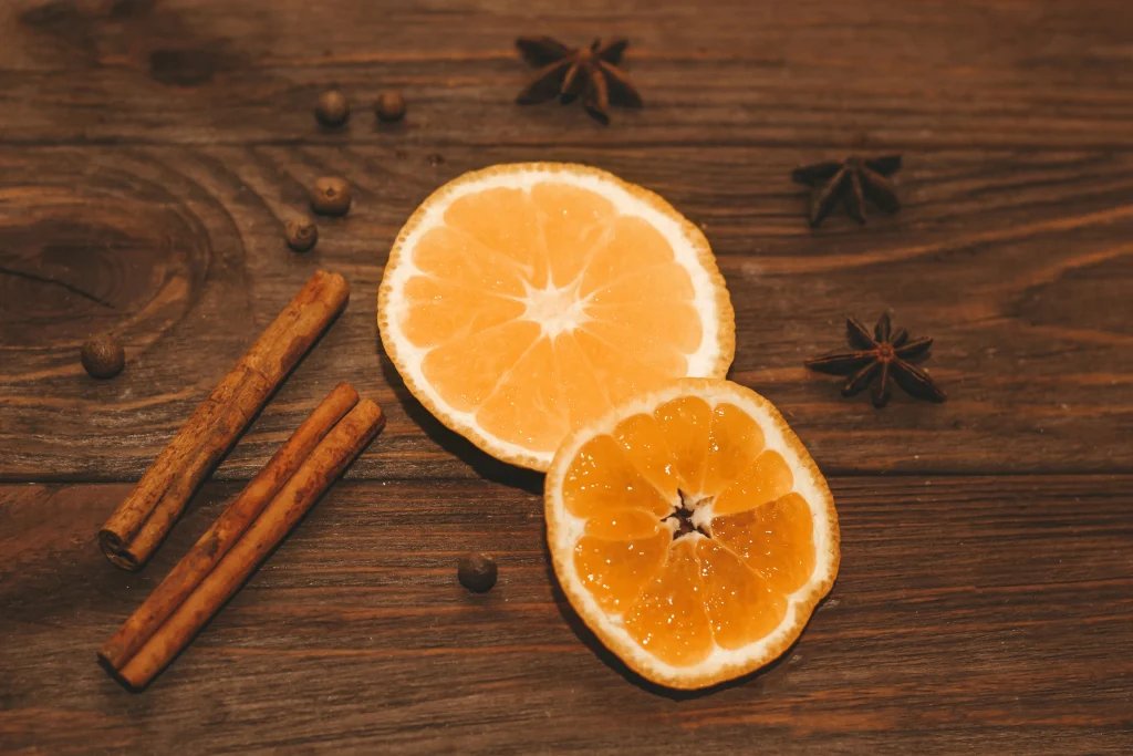 Orange, cinnamon, and Herbs on a counter top