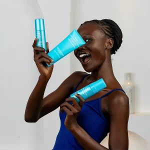 Dark Skinned model holding 3 products