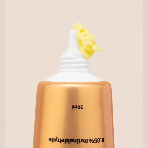 An Image of the a yellow coloured face cream coming out of a tube