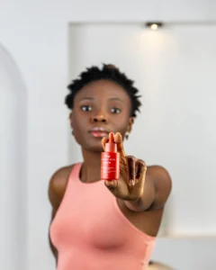 A lady holding a bottle of azelaic acid serum