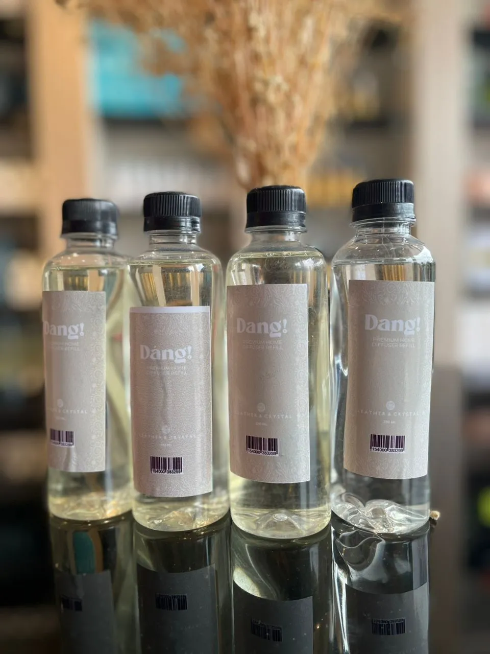 An image of four bottles of leather scented diffuser refill