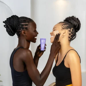 Dark skin model applying skincare product which is the Dang face moisturiser rich in ceramides and hydrating ingredients which is very essential for summer season
