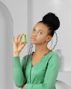 A model holding a bottle of niacinamide serum for oil control in her hands an effective product for caring for combination skin in summer