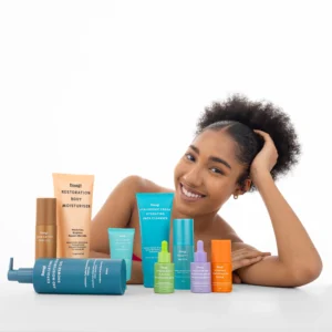 Woman smiling with several Dang! Lifestyle products laid in front of her