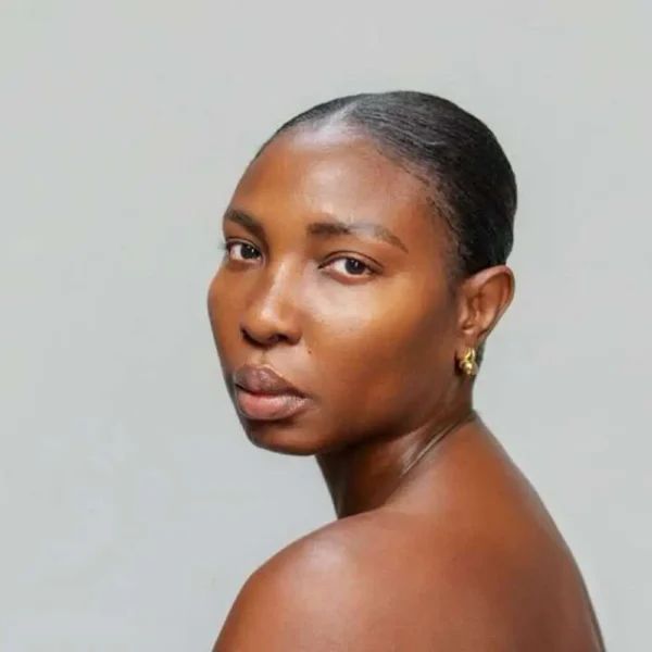 An image of a dark skinned woman showing her glowing skin the result of using the Ife's Glow kit